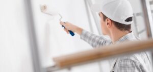 man painting house