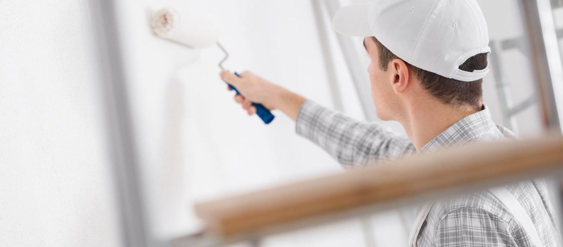 man painting house